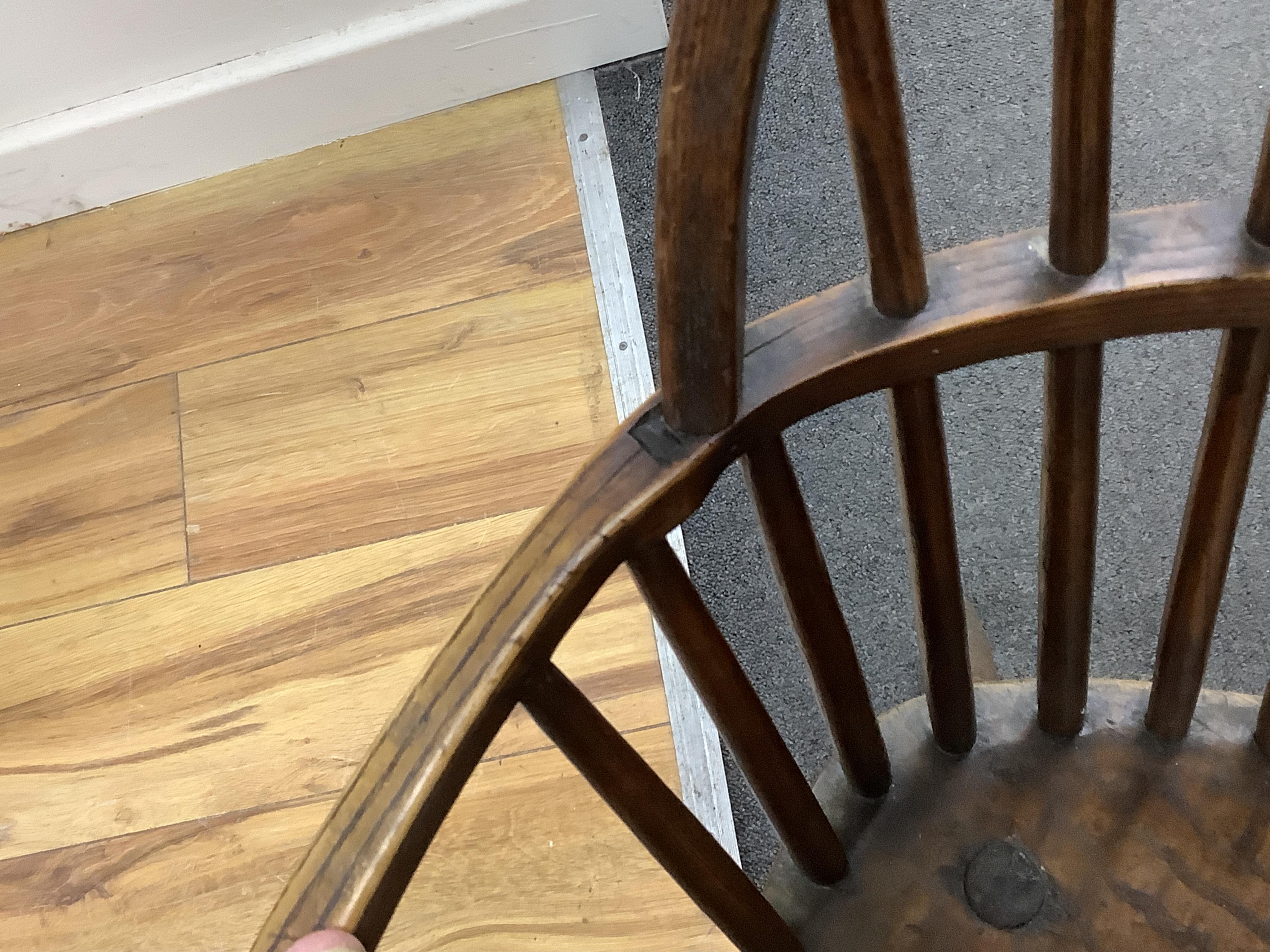 An early 19th century West Country ash and elm Windsor comb back elbow chair, width 57cm, depth 40cm, height 94cm